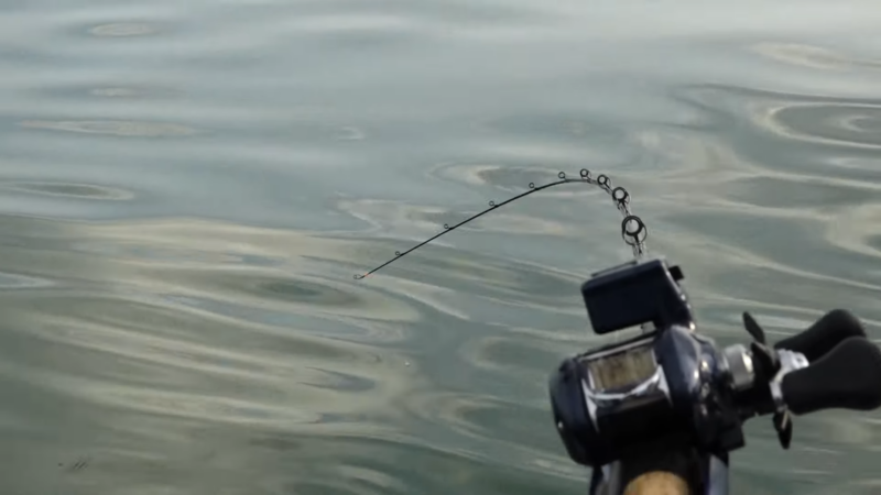 Fishing Rod with A Camera Attached, Angled Over Calm Water for Sauger Fishing