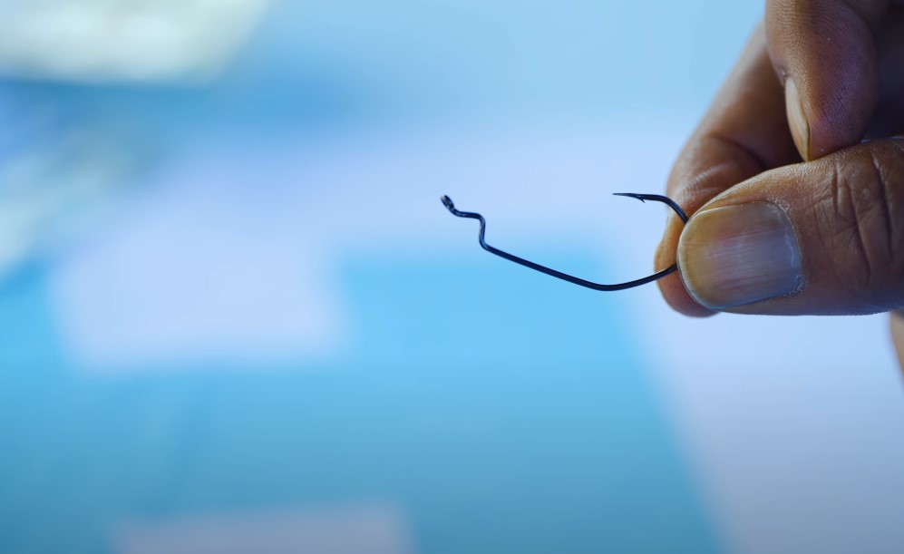 Close up photo of a hand holding fishing hook