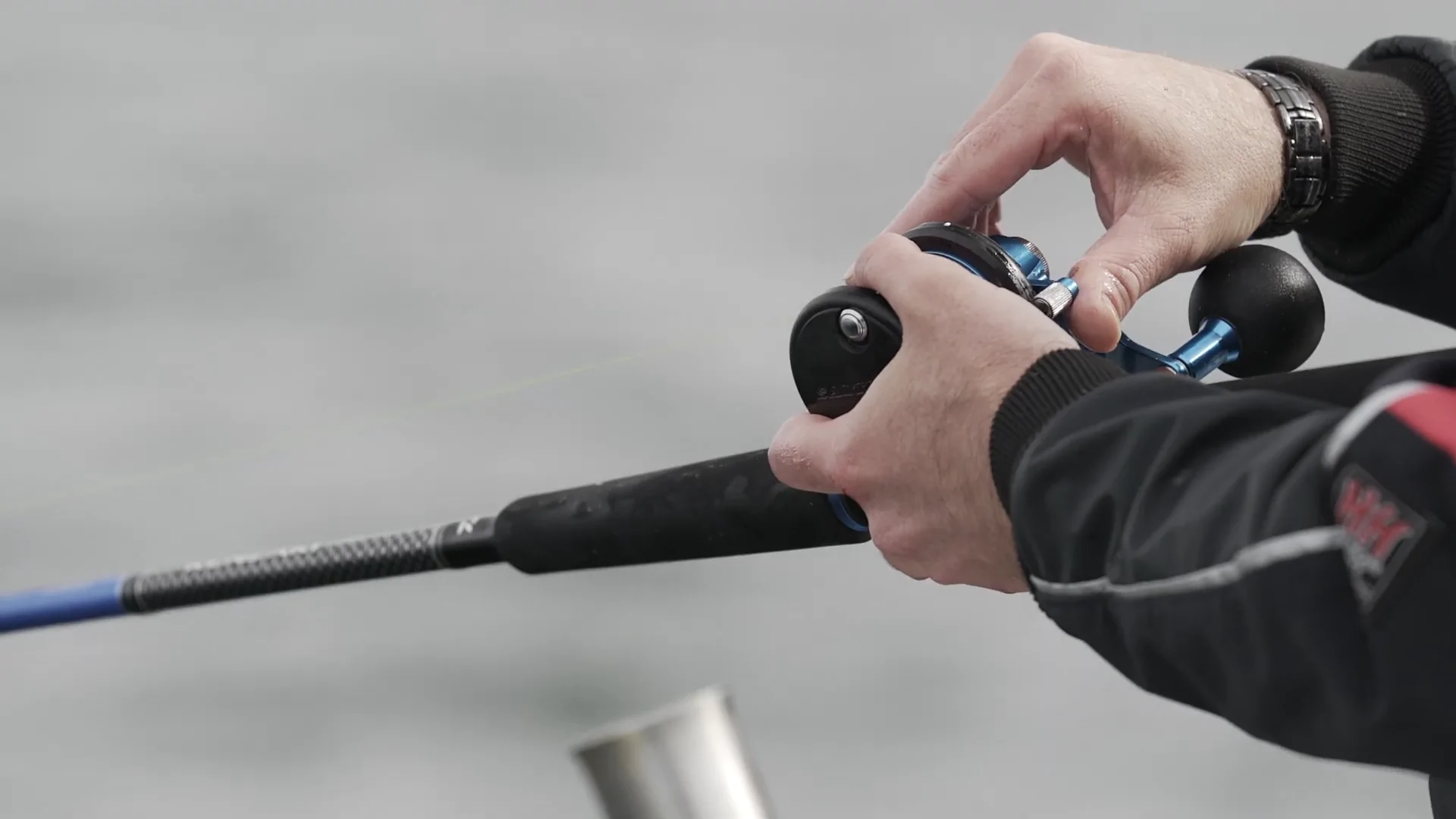 A Person Holding a Fishing Rod with A Braided Fishing Line in Hand